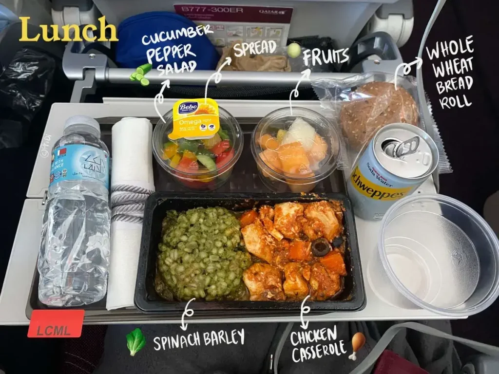 Low calorie meal lunch on Qatar Airways: Chicken casserole, spinach barley, cucumber-pepper raw salad, fruit cup, whole wheat bread roll and vegan spread