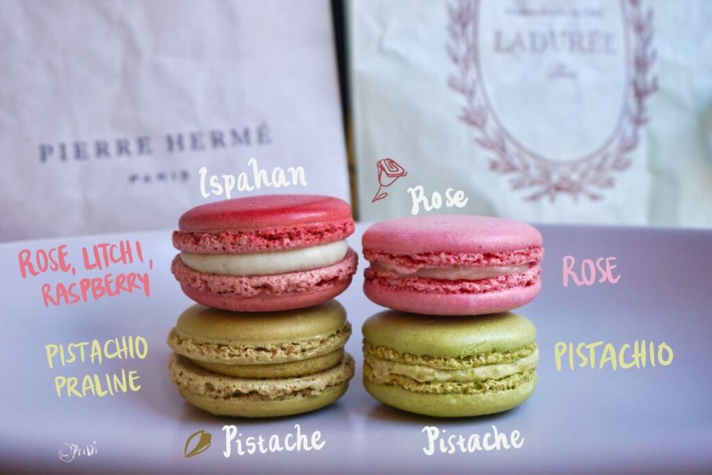 4 macarons from Pierre Hermé Paris and Maison Ladurée. Annotation showing flavors of the macarons: Ispahan, Pistache Pralinée, Rose, and Pistache