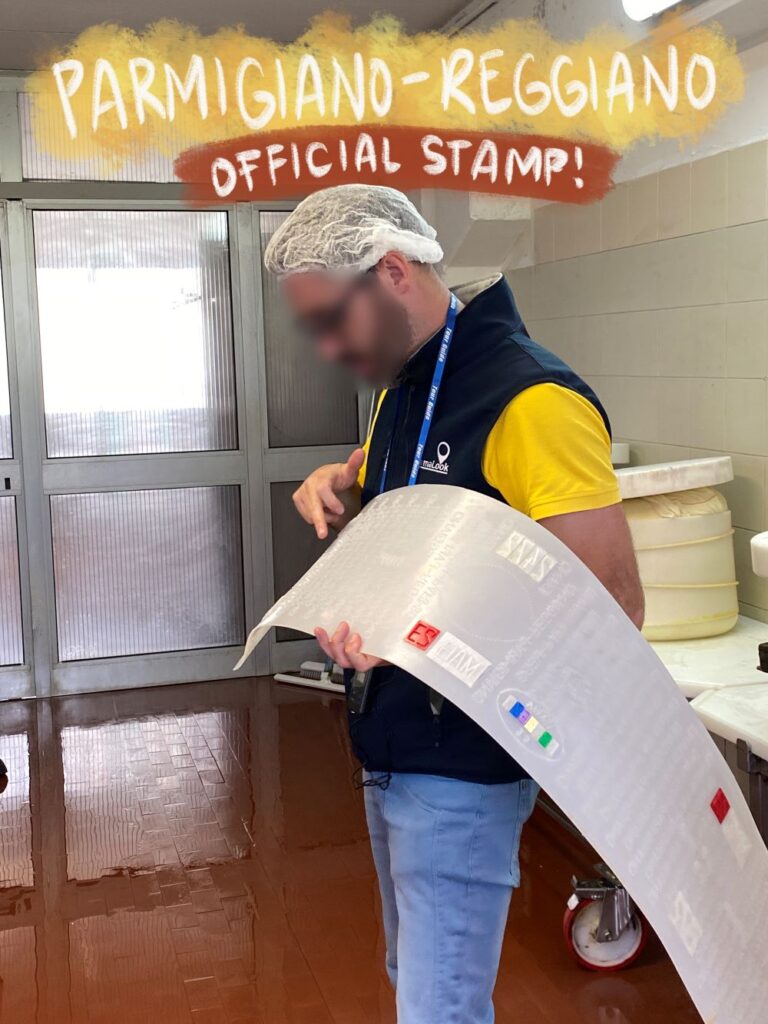 Our tour guide showing the official Parmigiano stamp, which will mark the outside of the wheel