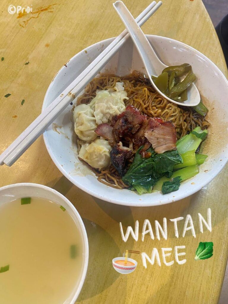 Bowl of dry noodles and dumplings and a bit of greens, a bowl of broth