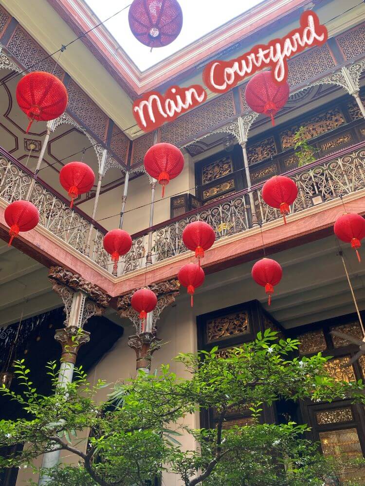 The center courtyard of the mansion, decorated with wrought iron and hanging red lanterns