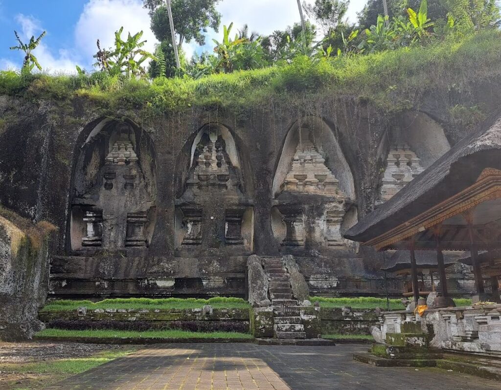 Stone reliefs on a cliffside with balinese cultural carvings, pura gunung kawi sebatu