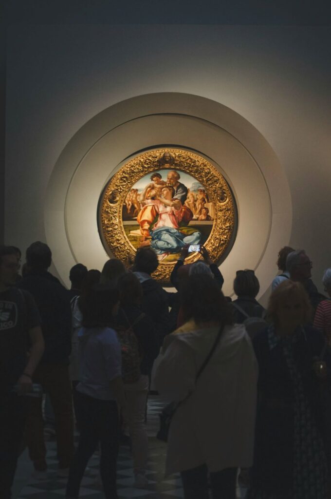 Tondo Doni painting by Michelangelo in the Uffizi Gallery surrounded by the crowd