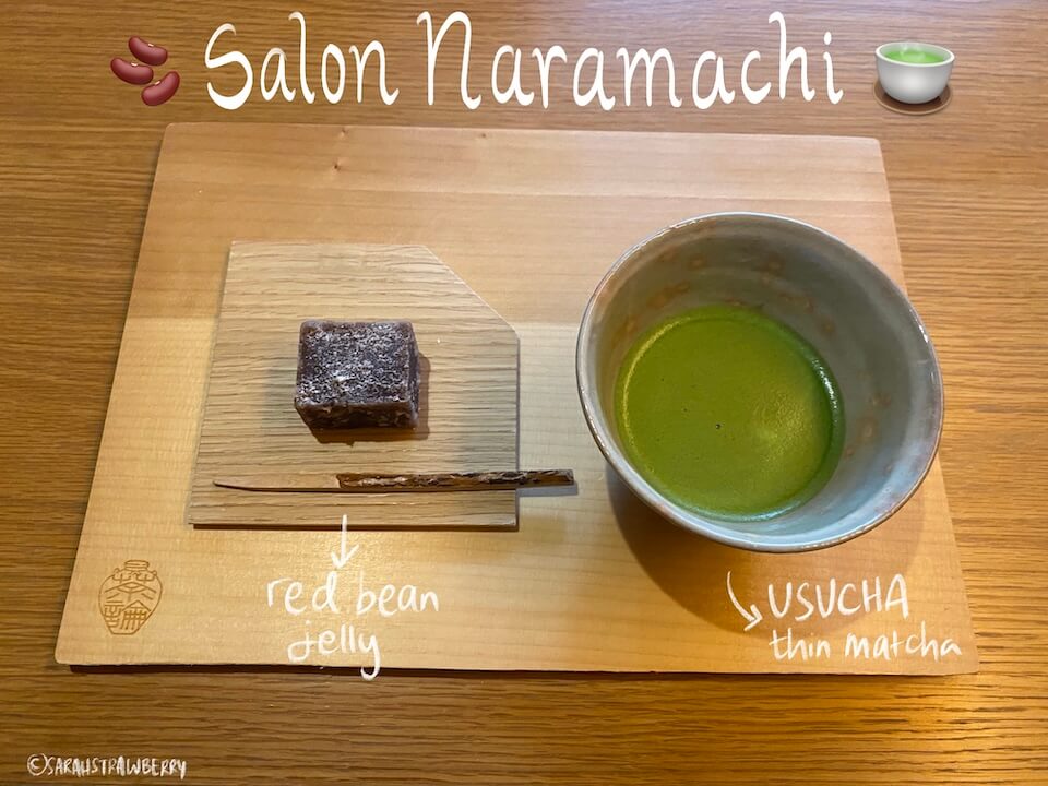 a bowl of matcha tea and red bean jelly snack on a wooden tray