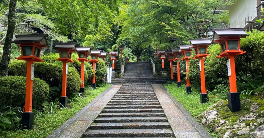 stone steps leading up with red japanese lanterns on the sides