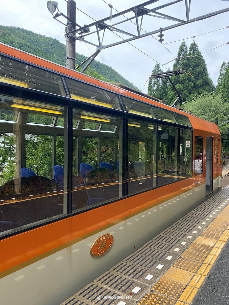 orange and white japanese train in the mountains