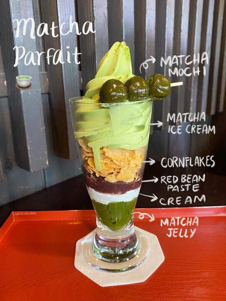 matcha parfait with layers of matcha jelly, cream, red bean paste, cornflakes, matcha soft serve ice cream, and matcha mochi