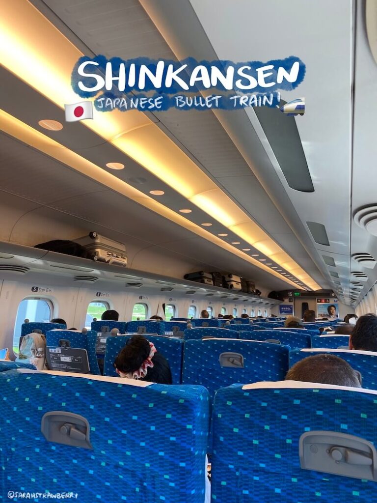 interior with blue rows of seating inside a shinkansen in Japan