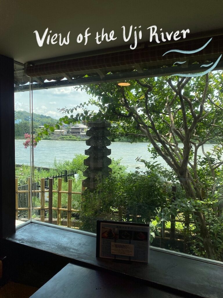 view of stone sculpture and uji river from a big window