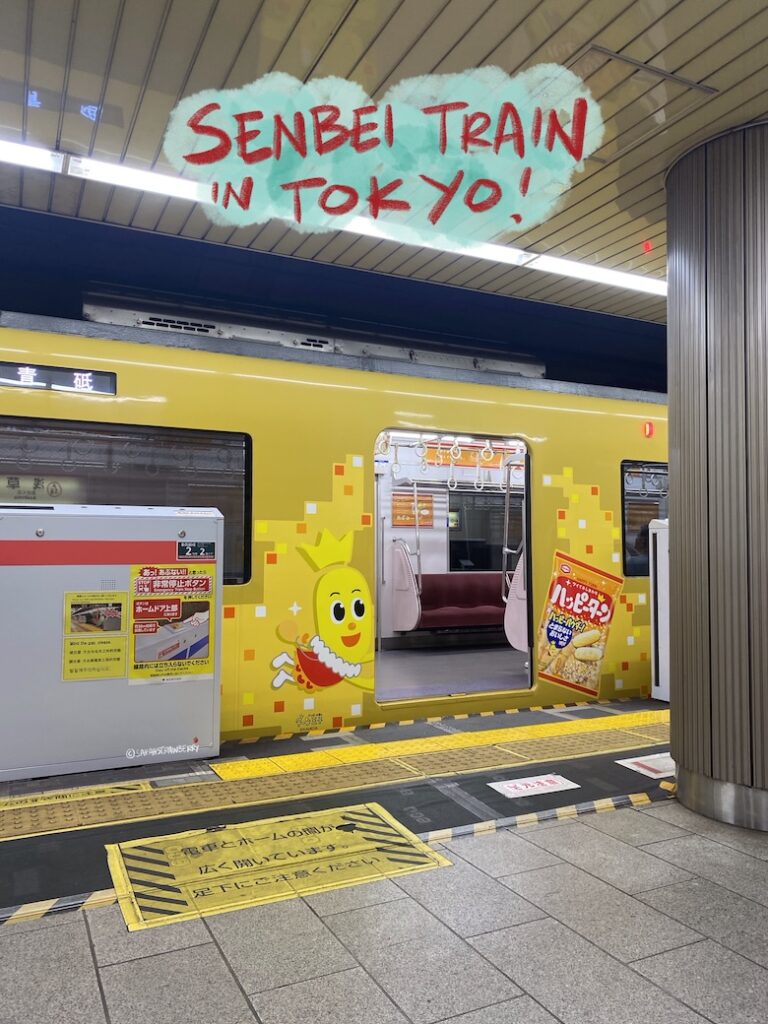 train in tokyo decorated in yellow with rice cracker illustrations