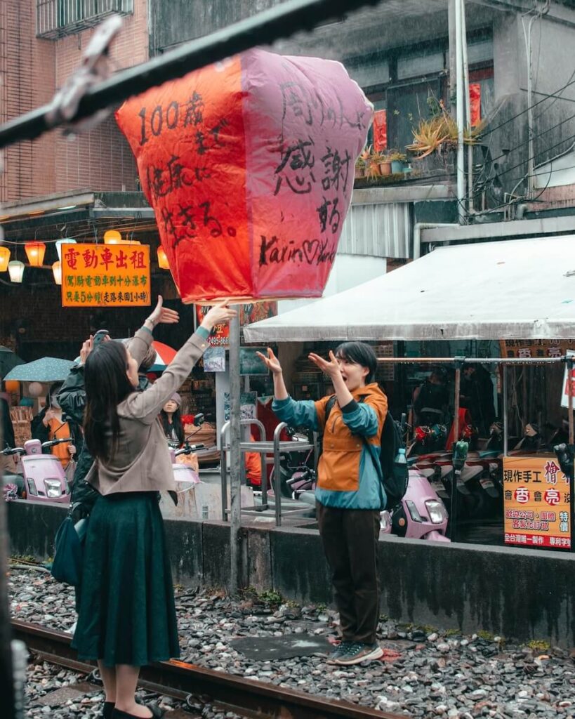 Couple flying wishing red lantern in Shifen Taiwan