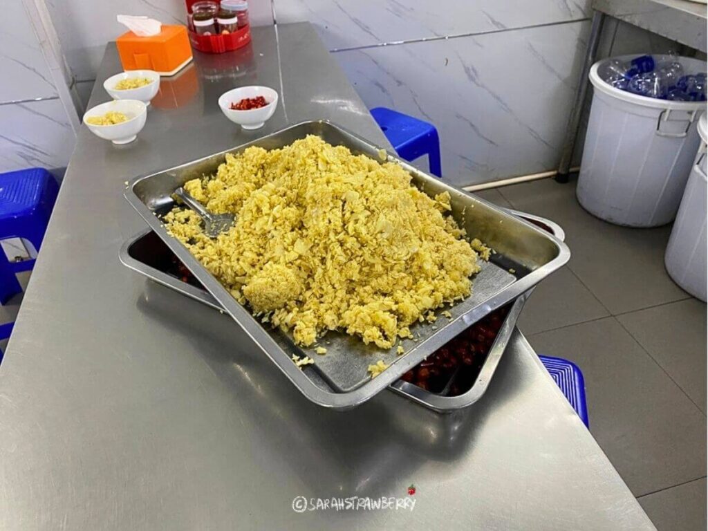 A mountainous pile of raw garlic at Bun Cha Huong Lien