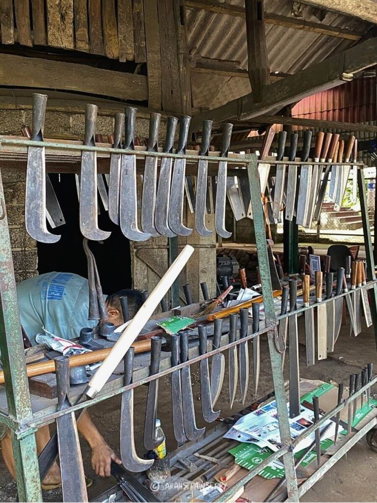 Knife artisan village in Nothern Vietnam. Knives lined up on metal bars for  display.