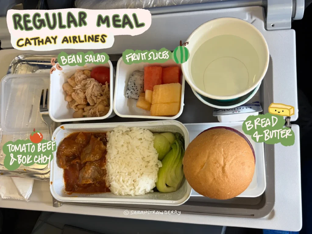 Airplane meal at Cathay; beef with rice, salad, fruits, bread roll, butter